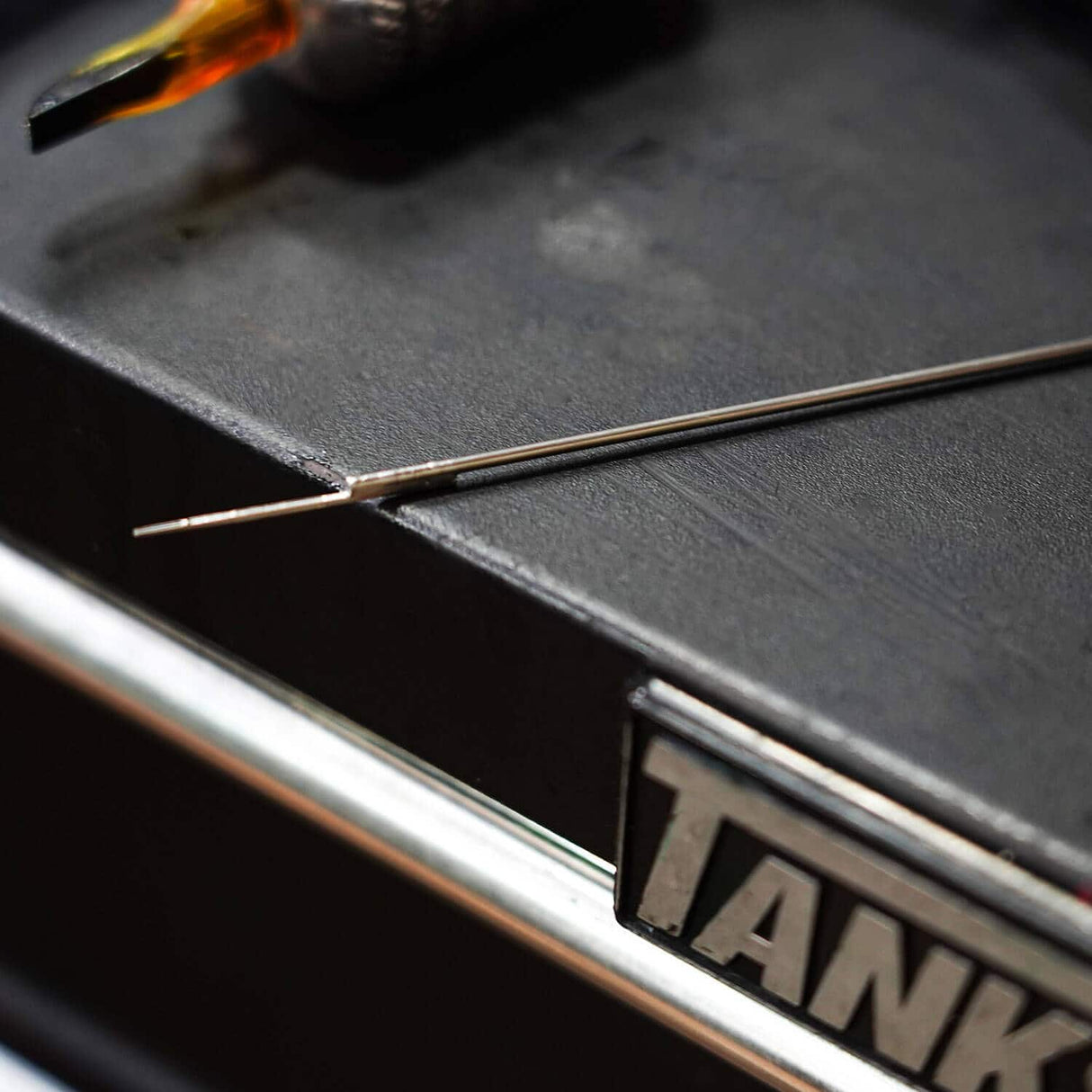 Tattoo needle with blue dot